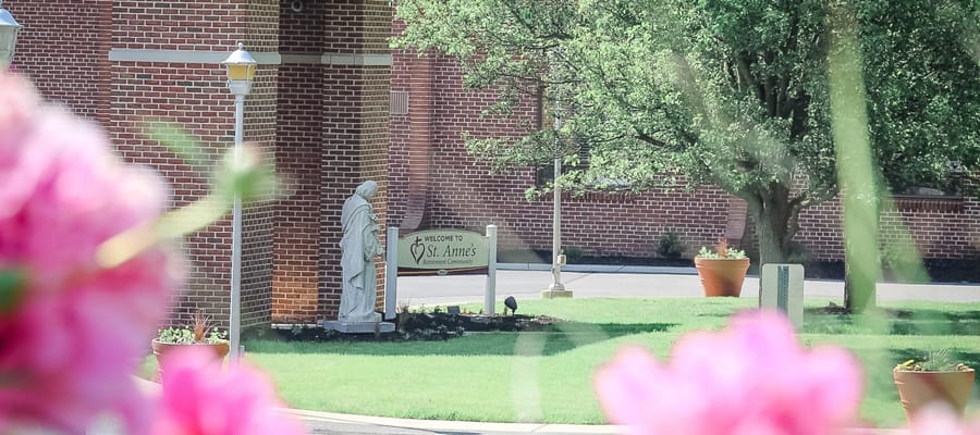 Exterior view of St. Anne's facility entrance with landscaping