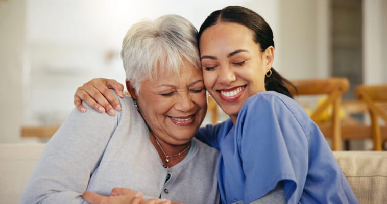 A caregiver and resident sharing a joyful moment together