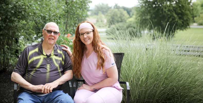 Senior resident and staff member enjoying outdoors