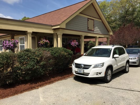 Exterior view of a senior living facility with flowers