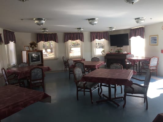 Dining room with tables and chairs in bright lighting