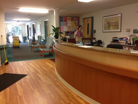 Reception area with staff member and seating