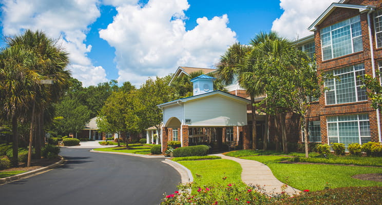 Pathway leading to a senior living facility with landscaping
