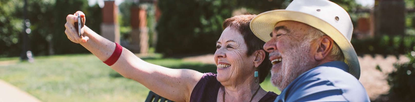 Two seniors enjoying a selfie in the garden