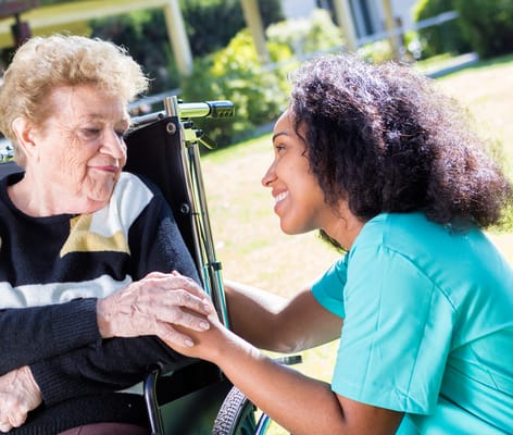 Caregiver interacting with a resident outdoors
