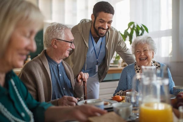 Residents and staff enjoying a meal together