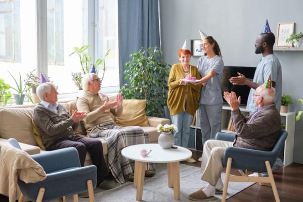 Residents celebrating a birthday in a cozy common area
