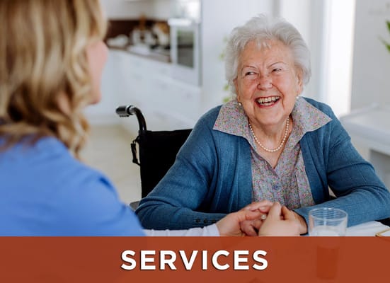 A caregiver and a smiling resident enjoying a conversation