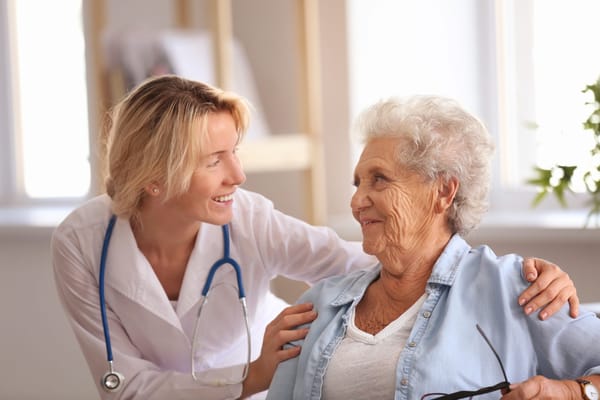 Nurse interacting warmly with a senior resident