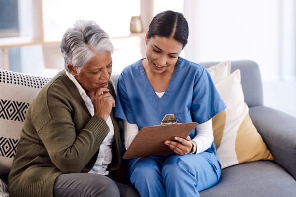 Caregiver discussing with a resident in a cozy lounge