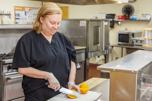 Staff member preparing food in the kitchen