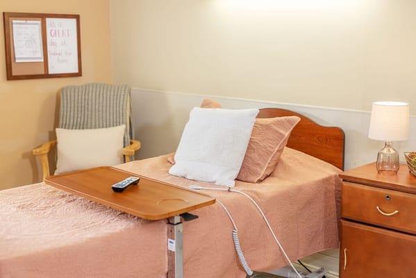 Cozy resident room with a bed and wooden furniture