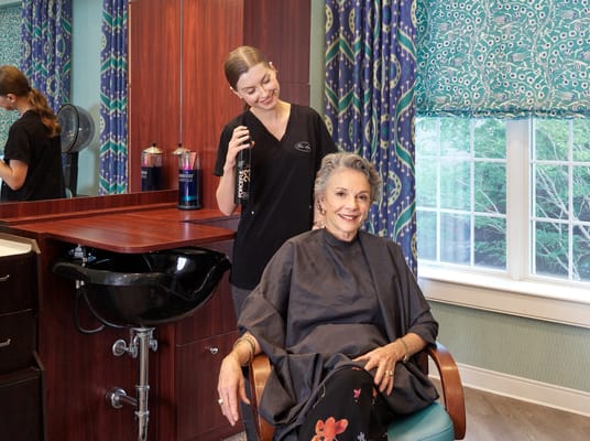 Resident receiving a haircut in the salon
