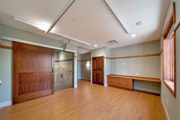 Spacious interior of a resident room with wood accents