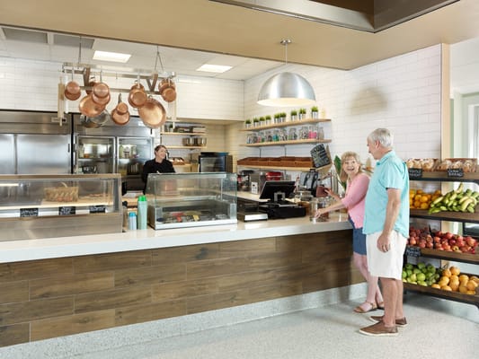 Residents enjoying food service at a dining area