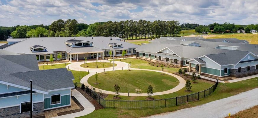 Aerial view of a senior living facility with gardens