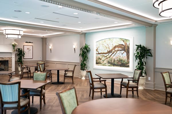 Bright common area with tables and artwork