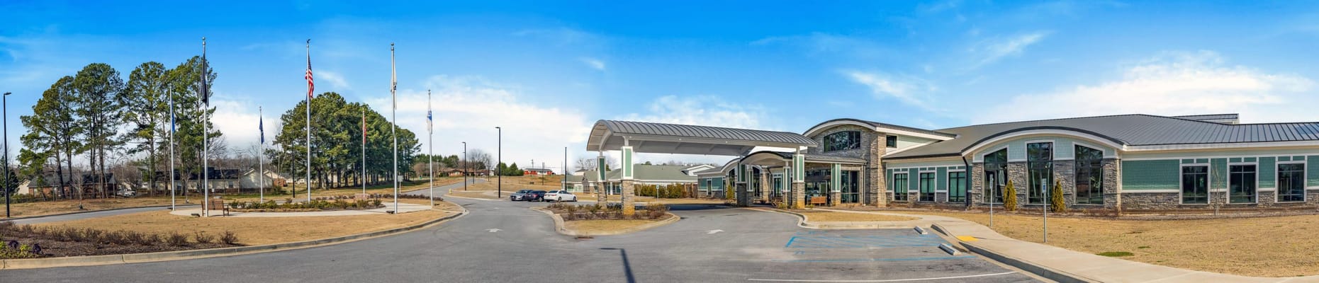 Exterior view of a senior living facility with flags