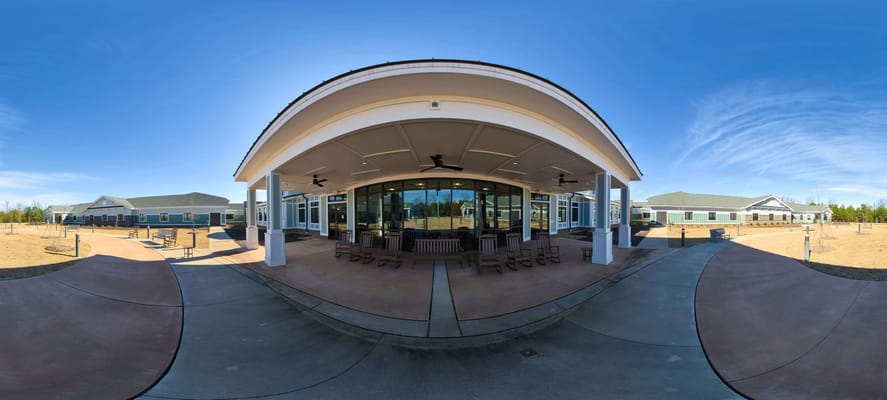 Exterior view of a senior living facility with seating area
