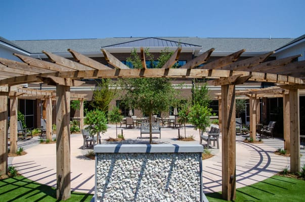 Outdoor courtyard with wooden pergola and seating