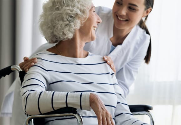Caregiver assisting a resident in a wheelchair