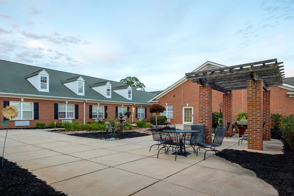 Outdoor patio area with seating and gardens