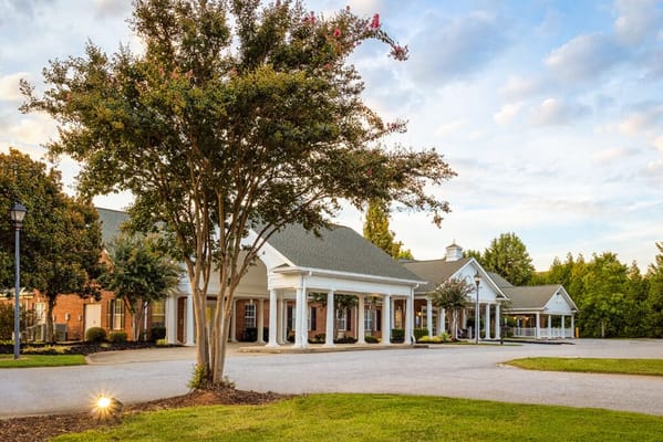Exterior view of a senior living facility with landscaping
