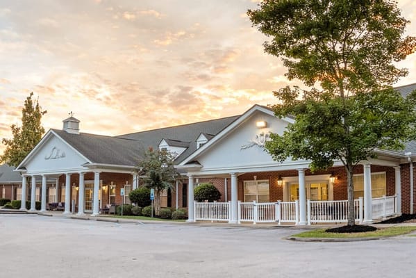 Exterior view of a senior living facility at sunset