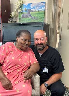 Resident and staff member posing for a photo