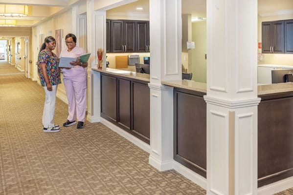Staff members discussing in a facility hallway