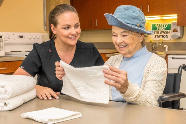 Caregiver assisting a senior resident with an activity