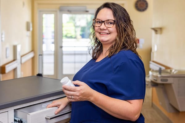 Nurse standing at a desk in a facility