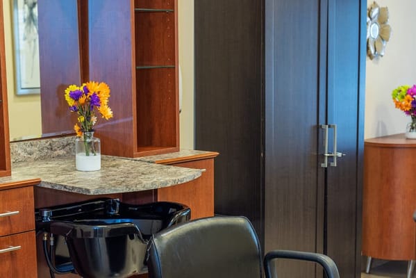 Hair salon space with flowers and a chair