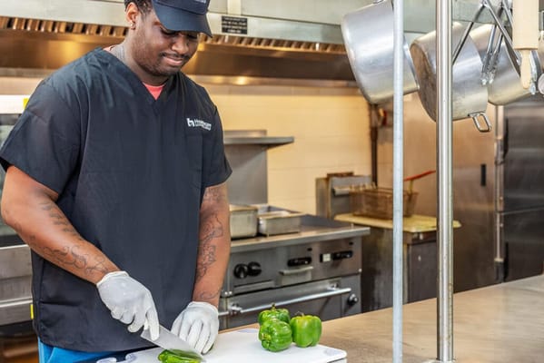 Staff member preparing food in the kitchen