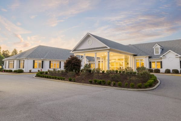 Exterior view of a senior living facility during sunset