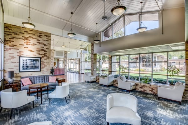 Bright common area with large windows and seating