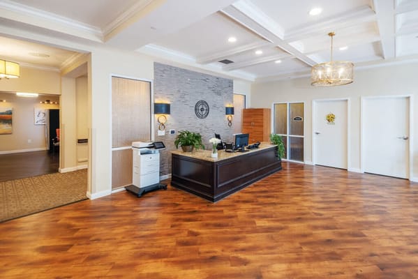 Bright lobby area with wooden floors and reception desk
