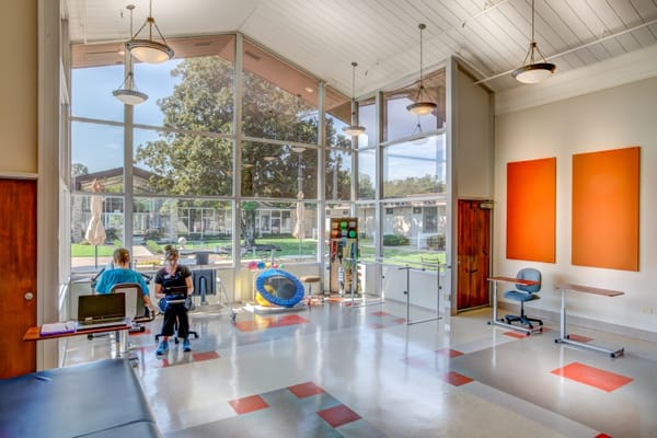 Interior of a bright common area with residents and staff