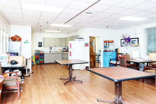 Bright activity room with tables and chairs