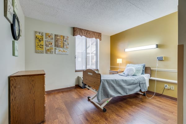 Private resident room with a hospital bed and decor