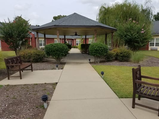 Pathway leading to a gazebo in a landscaped garden