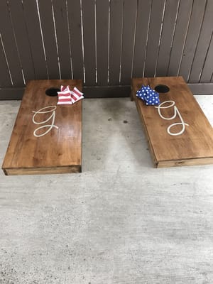 Bean bag toss game setup on a patio