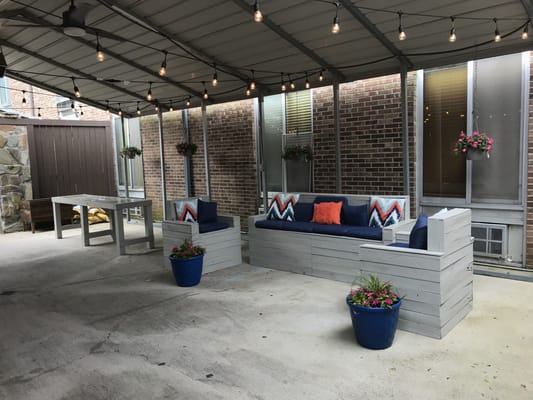 Cozy outdoor seating area with planters and lights