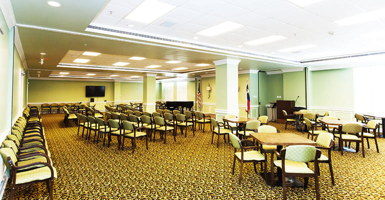 Bright common area with seating and piano