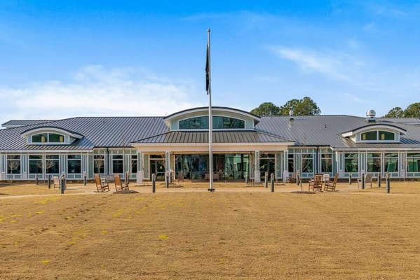 Front view of a senior living facility with a grassy area