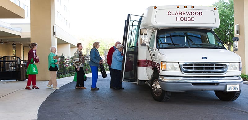 Residents boarding a facility transport van