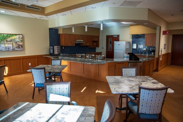 Bright dining area with tables and a food service counter