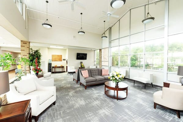 Bright common area with comfortable seating and plants
