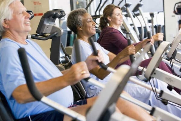 Residents participating in a fitness activity in a gym