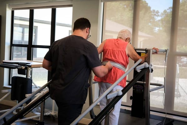 Senior resident assisted with therapy equipment